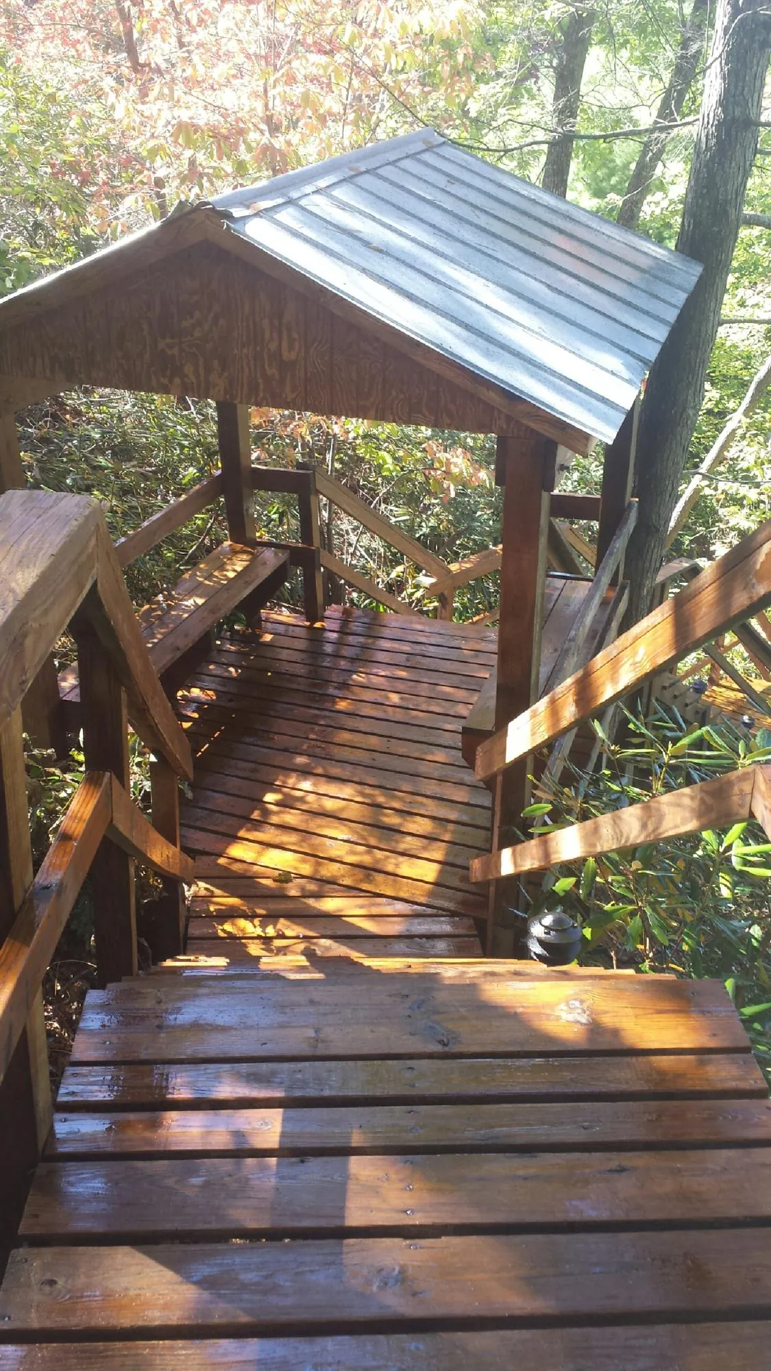 Freshly stained wood walkway and covered shelter with a metal roof in Charleston Afb