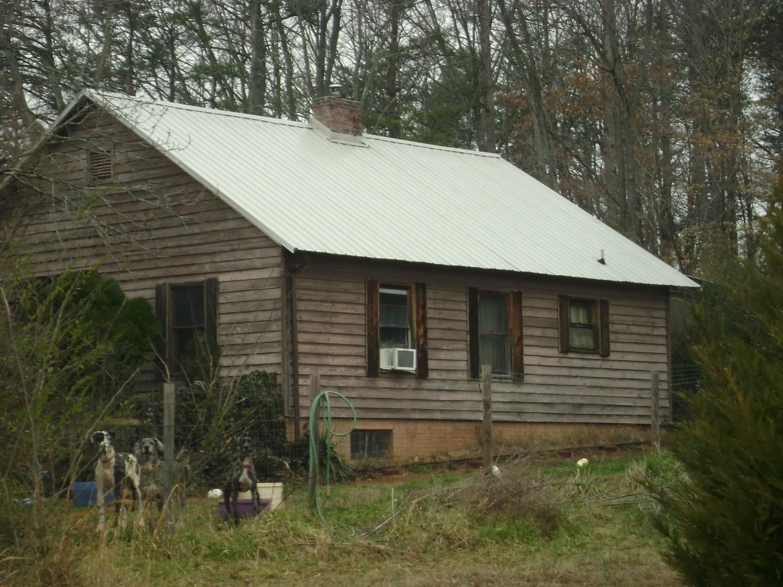 White metal roof on an old wood sided farmhouse, from a Metal Roof Installation job in Charleston Afb